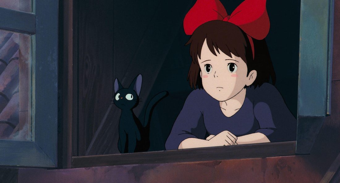 Jiji, sentado en el alféizar junto a Kiki, mirando hacia la calle