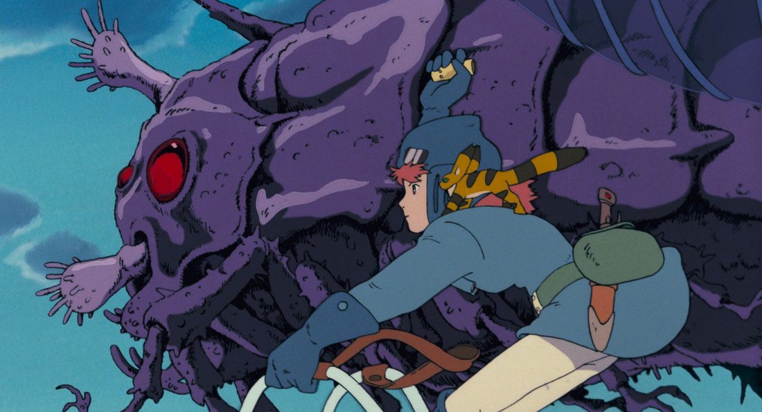 Cabeza de un ohmu con el ojo rojo, con Nausicaä tumbada encima