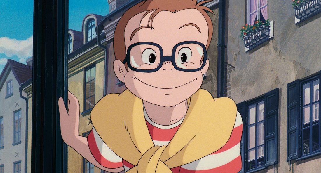 Primer plano de Tombo con sus gafas redondas y el jersey al cuello