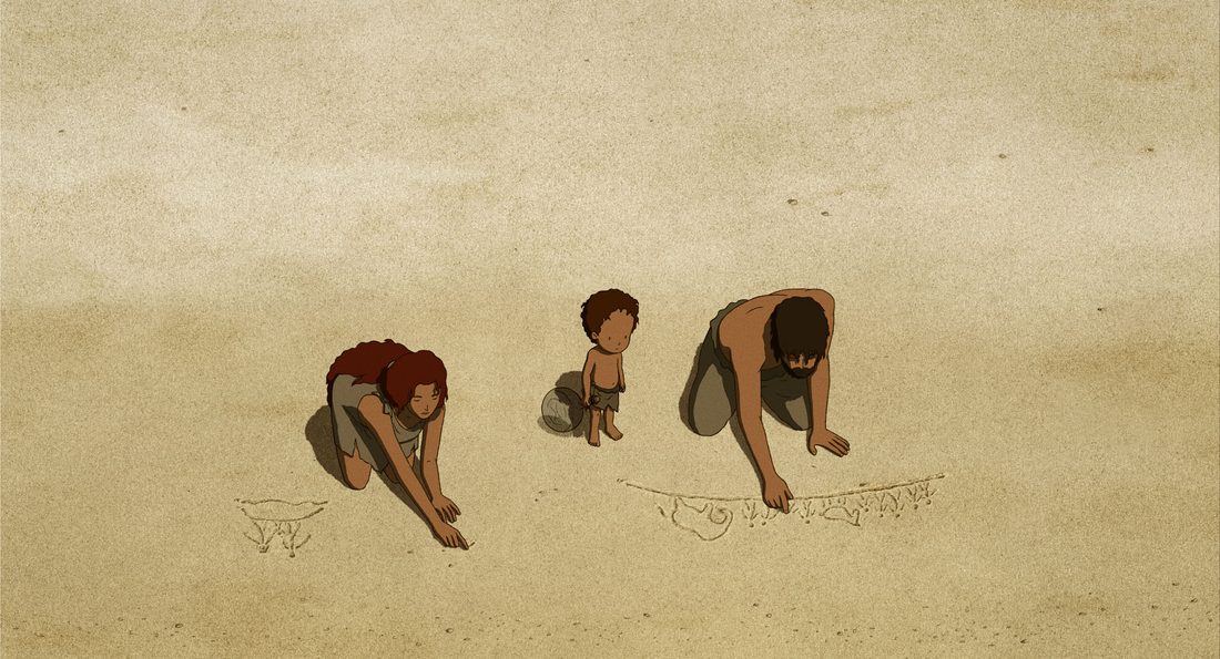 El hijo dibuja en la arena entre su padre y su madre