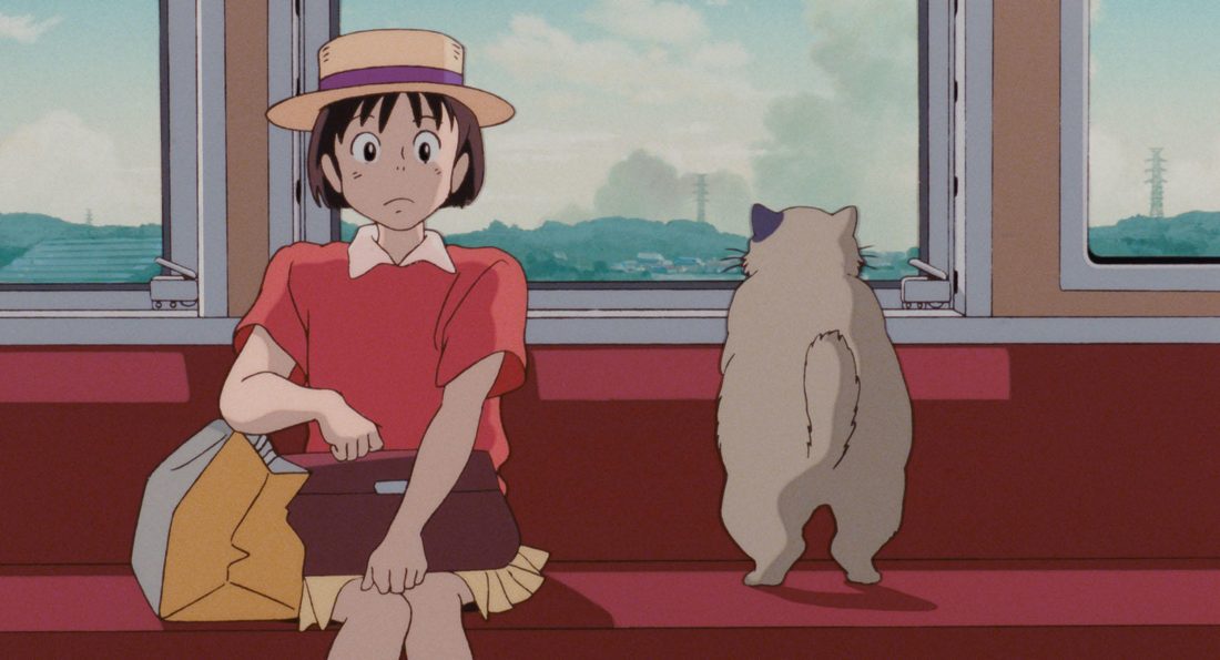 Muta, de pie en el asiento del tren, junto a Shizuku