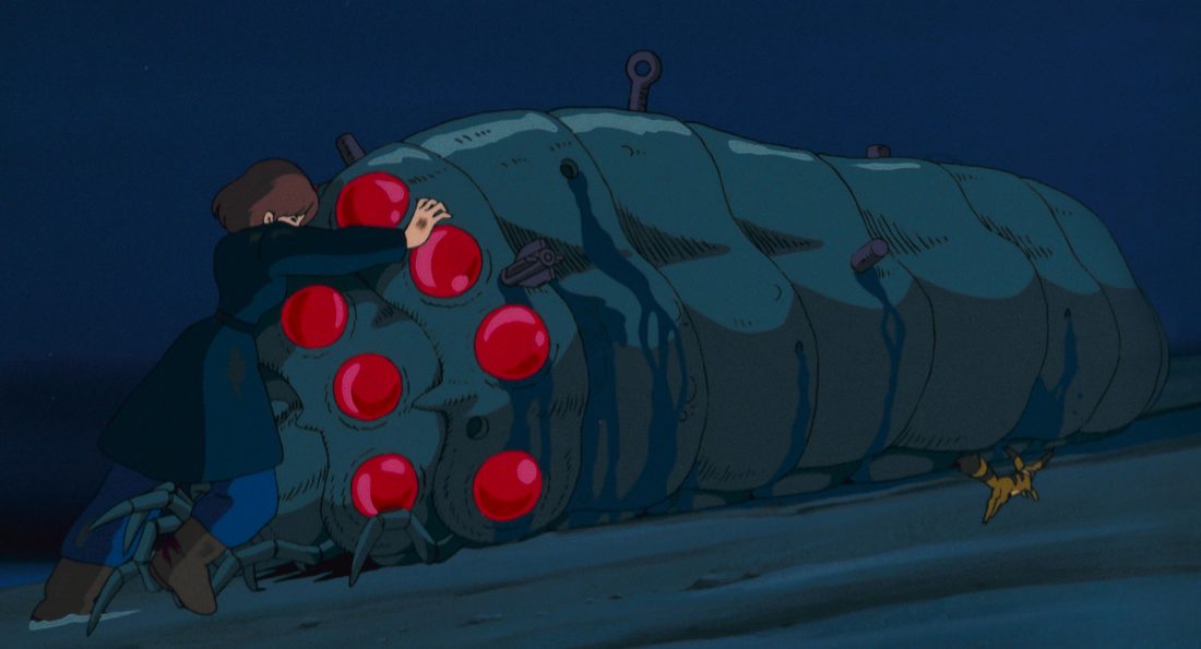 Un ohmu tumbado, con los ojos rojos, ante Nausicaä